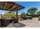 The outdoor living area boasts comfortable seating, a pergola, and mature landscaping for ultimate relaxation at 29403 N 119Th Ln, Peoria, AZ 85383