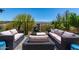The charming outdoor living space features plush seating, a fountain, and desert landscaping at 29403 N 119Th Ln, Peoria, AZ 85383