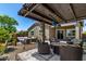 The outdoor patio offers shaded seating beneath a pergola, with desert landscaping and string lights at 29403 N 119Th Ln, Peoria, AZ 85383