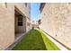A backyard features modern artificial turf creating a low-maintenance and inviting outdoor living space at 302 N 69Th Pl, Mesa, AZ 85207