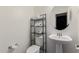 Cozy half-bathroom with stylish toilet, sink and round mirror at 302 N 69Th Pl, Mesa, AZ 85207