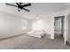 Carpeted bedroom with ceiling fan and a comfortable mattress on the floor at 302 N 69Th Pl, Mesa, AZ 85207