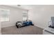 Bright bedroom featuring a large window, neutral carpet, and trim creating a cozy and inviting space at 302 N 69Th Pl, Mesa, AZ 85207