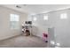 Bright bonus room with desk, chair, two monitors, and plenty of natural light at 302 N 69Th Pl, Mesa, AZ 85207