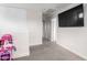 Versatile bonus room with a large TV, neutral colors, and open layout at 302 N 69Th Pl, Mesa, AZ 85207