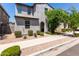 Charming two-story home featuring a textured facade, arched entryway, and well-maintained desert landscaping at 302 N 69Th Pl, Mesa, AZ 85207