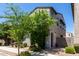 Charming two-story home featuring a textured facade, arched entryway, and well-maintained desert landscaping at 302 N 69Th Pl, Mesa, AZ 85207