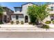 Charming two-story home featuring a textured facade, arched entryway, and well-maintained desert landscaping at 302 N 69Th Pl, Mesa, AZ 85207