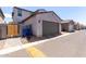 Exterior of single Gathering home with a large garage and desert landscaping for low maintenance at 302 N 69Th Pl, Mesa, AZ 85207