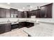 A bright kitchen with granite countertops, stainless appliances, and ample cabinet space at 302 N 69Th Pl, Mesa, AZ 85207