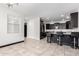 Stylish kitchen with black cabinets, tile flooring and barstool seating at the island at 302 N 69Th Pl, Mesa, AZ 85207