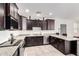 Modern kitchen design with granite countertops, stainless steel appliances, and dark cabinetry at 302 N 69Th Pl, Mesa, AZ 85207