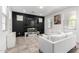 Modern living room with tile floors, a black accent wall, and contemporary white furniture at 302 N 69Th Pl, Mesa, AZ 85207