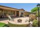 Beautiful backyard patio with built-in fireplace, outdoor dining, barbecue, and desert landscaping at 3336 W Morse Dr, Anthem, AZ 85086