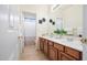 Bathroom with tile flooring, wooden cabinets, double sinks, large mirror, and shower/tub combo at 3336 W Morse Dr, Anthem, AZ 85086