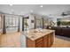 Open kitchen with granite island and seating, seamlessly flowing into the sunny living area at 3336 W Morse Dr, Anthem, AZ 85086