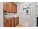 Laundry room with ample wood cabinetry, folding counter, white washer/dryer, and tile flooring at 3336 W Morse Dr, Anthem, AZ 85086