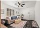 Spacious living room with plush grey sofa, patterned rug, dark wood-look flooring, and bright natural light at 3336 W Morse Dr, Anthem, AZ 85086