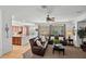 Bright living room featuring a leather sofa set, neutral walls, and an adjacent kitchen area at 3336 W Morse Dr, Anthem, AZ 85086