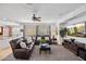 Cozy living room with plush seating, ceiling fan, and entertainment center with modern television at 3336 W Morse Dr, Anthem, AZ 85086