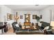 Comfortable living room featuring leather furnishings, desert decor, and tile floors at 3336 W Morse Dr, Anthem, AZ 85086