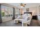 Bright main bedroom with plush seating area, plantation shutters and a ceiling fan for added comfort at 3336 W Morse Dr, Anthem, AZ 85086
