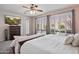 Bright main bedroom with plantation shutters, ceiling fan and tv offers cozy living at 3336 W Morse Dr, Anthem, AZ 85086