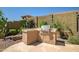 An outdoor kitchen features a built-in grill and stone counters, perfect for backyard entertaining at 3336 W Morse Dr, Anthem, AZ 85086