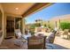 Outdoor patio features a built-in grill, dining area, and lush landscaping, perfect for outdoor gatherings at 3336 W Morse Dr, Anthem, AZ 85086