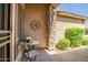 Cozy patio with stone columns, decorative sun art, and comfortable seating area at 3336 W Morse Dr, Anthem, AZ 85086