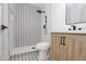 Modern bathroom featuring a glass shower, wood-look vanity, and black hardware at 4115 W Sierra St, Phoenix, AZ 85029