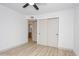 Bright bedroom featuring luxury vinyl flooring and closet with sliding doors at 4115 W Sierra St, Phoenix, AZ 85029