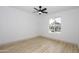 Spacious bedroom featuring luxury vinyl flooring, a ceiling fan and view to the exterior at 4115 W Sierra St, Phoenix, AZ 85029