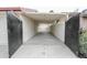 Spacious carport area behind the wrought iron gate provides ample secure parking for vehicles at 4115 W Sierra St, Phoenix, AZ 85029