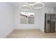 Modern dining area featuring a stainless steel refrigerator and modern light fixtures at 4115 W Sierra St, Phoenix, AZ 85029