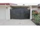 A secure wrought iron gate provides access to the carport with ample space for vehicles at 4115 W Sierra St, Phoenix, AZ 85029