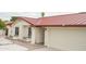 Well-maintained exterior showcasing a red metal roof, white brick, and a two-car garage at 4115 W Sierra St, Phoenix, AZ 85029