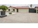 Traditional style home boasts a metal roof, charming white brick facade, and a long driveway at 4115 W Sierra St, Phoenix, AZ 85029