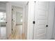 Hallway with open doors to bedrooms featuring wood-look flooring at 4115 W Sierra St, Phoenix, AZ 85029