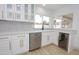 Updated kitchen featuring white cabinetry with gold hardware, stainless appliances and a beverage refrigerator at 4115 W Sierra St, Phoenix, AZ 85029