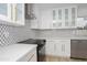 Modern kitchen featuring stainless appliances, white cabinets with gold hardware and a geometric backsplash at 4115 W Sierra St, Phoenix, AZ 85029