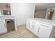Modern kitchen island featuring white cabinetry with gold hardware, and a beverage refrigerator at 4115 W Sierra St, Phoenix, AZ 85029