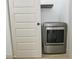 Modern washing machine in a laundry nook, enclosed by a white sliding door at 4115 W Sierra St, Phoenix, AZ 85029