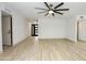 Spacious open-concept living room with modern ceiling fan and stylish laminate floors at 4115 W Sierra St, Phoenix, AZ 85029