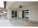 Outdoor covered patio featuring tile flooring and dual sliding glass doors leading into the home at 4115 W Sierra St, Phoenix, AZ 85029