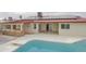 Aerial view of pool with solar panels, covered patio, and outdoor kitchen at 4115 W Sierra St, Phoenix, AZ 85029