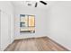 Minimalist bedroom with clean lines, neutral color palette, ceiling fan, and a large window at 4220 N 32Nd St # 21, Phoenix, AZ 85018