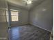 Bedroom with wood-look tile flooring, a window, and neutral walls, creating a serene living space at 4255 E Rock Dr, San Tan Valley, AZ 85143