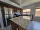 Modern kitchen featuring stainless steel appliances, granite countertops, and a kitchen island for extra counter space at 4255 E Rock Dr, San Tan Valley, AZ 85143