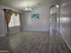 Open living room with wood-look tile floors, chandelier, and abundant natural light at 4255 E Rock Dr, San Tan Valley, AZ 85143